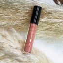 Brick Lip Gloss by Sérénité Soin in sleek gloss tube packaging designed for bold tinted shine and everyday wear.